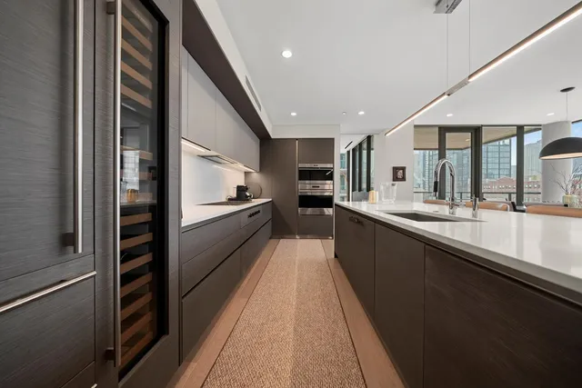 a large kitchen with a large counter top appliances and cabinets
