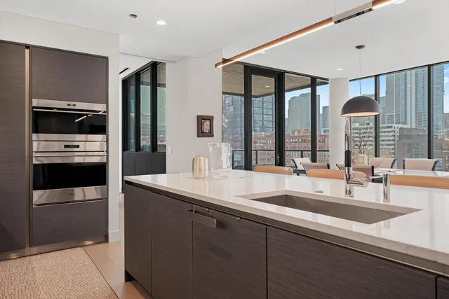a kitchen with stainless steel appliances a sink and a refrigerator