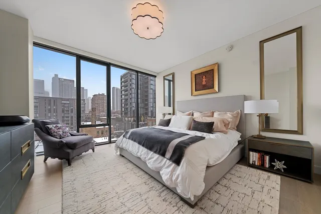 a spacious bedroom with a bed and a large window