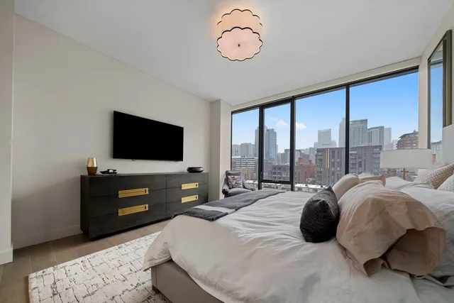 a large bedroom with a bed and large window