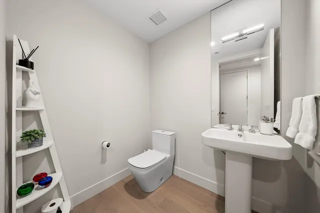 a bathroom with a sink toilet and vanity