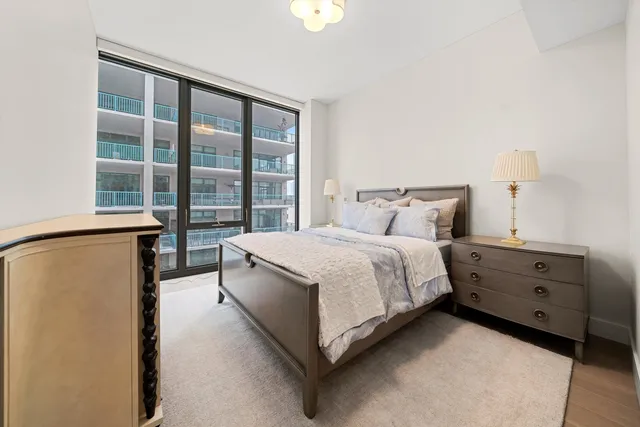 a bedroom with a bed and a night stand