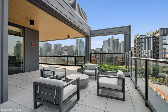 a balcony with furniture and a potted plant