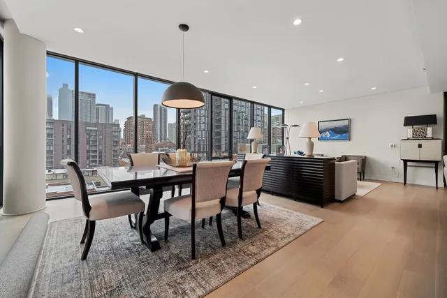 a dining room with furniture and a floor to ceiling window