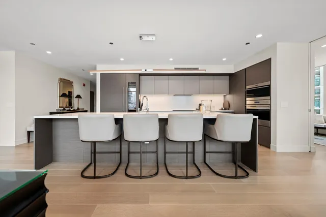 a kitchen with a sink cabinets and white stainless steel appliances