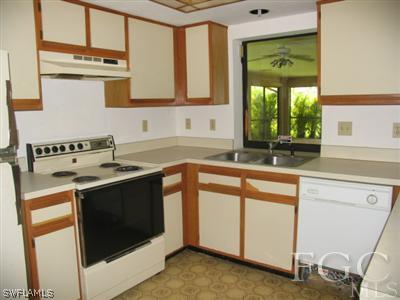 17461 Fuchsia Road Fort Myers, FL 33967 - Photo 3 of 5 a kitchen with stainless steel appliances granite countertop a sink stove and cabinets