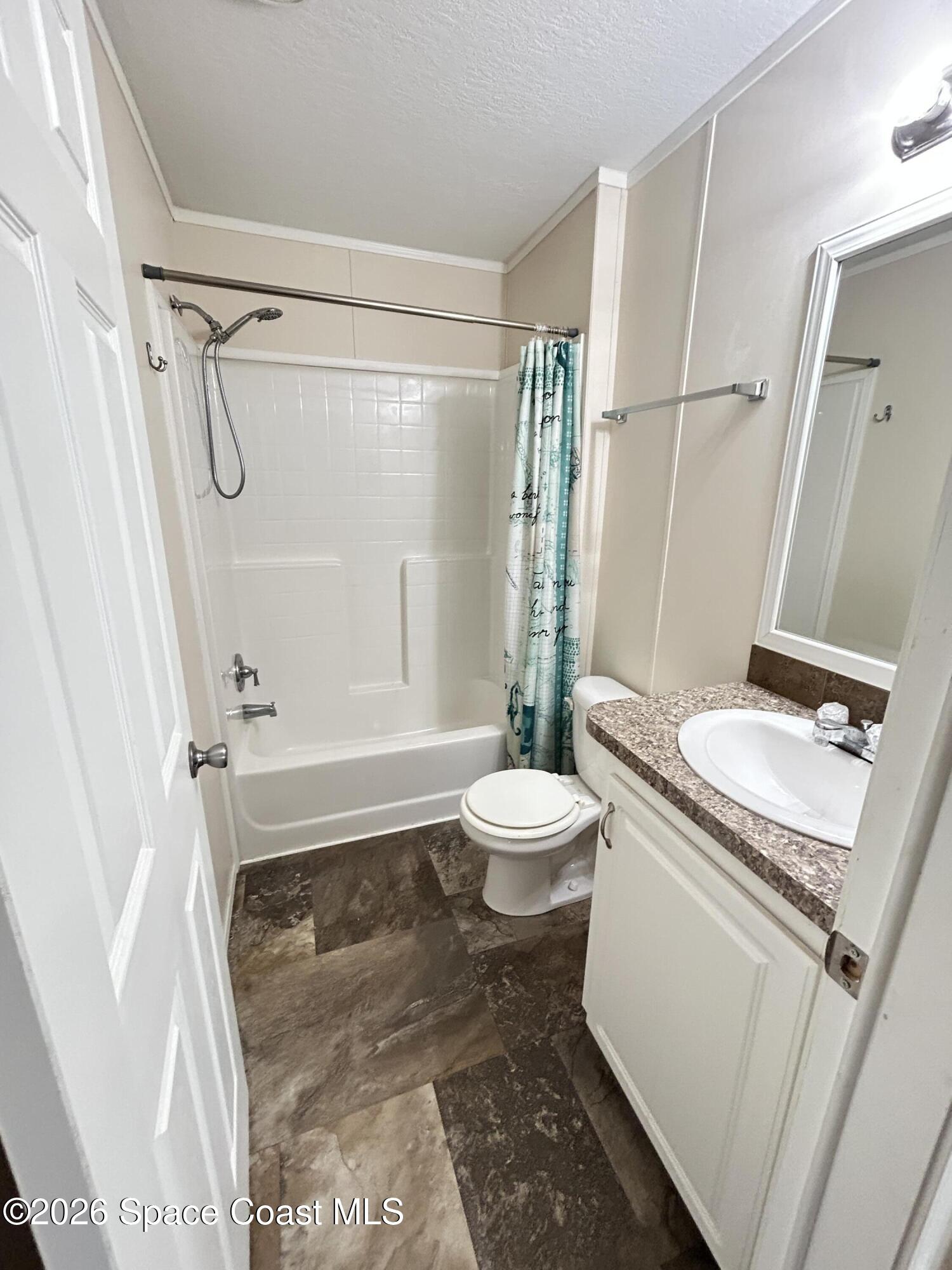 117 Lewis Street Edgewater, FL 32141 - Photo 19 of 26 a bathroom with a granite countertop sink toilet and shower