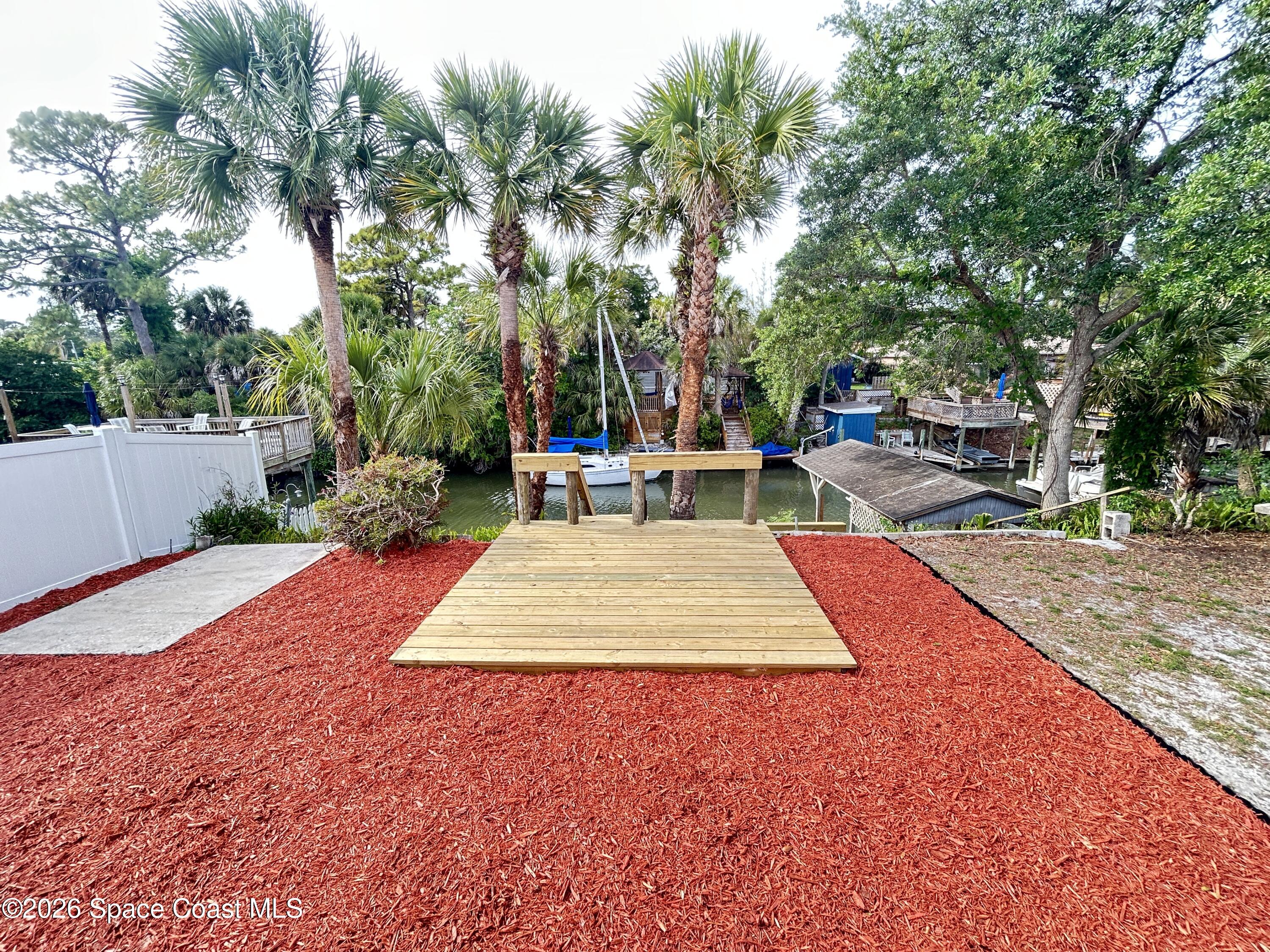 117 Lewis Street Edgewater, FL 32141 - Photo 22 of 26 a wooden bench sitting in middle of a yard