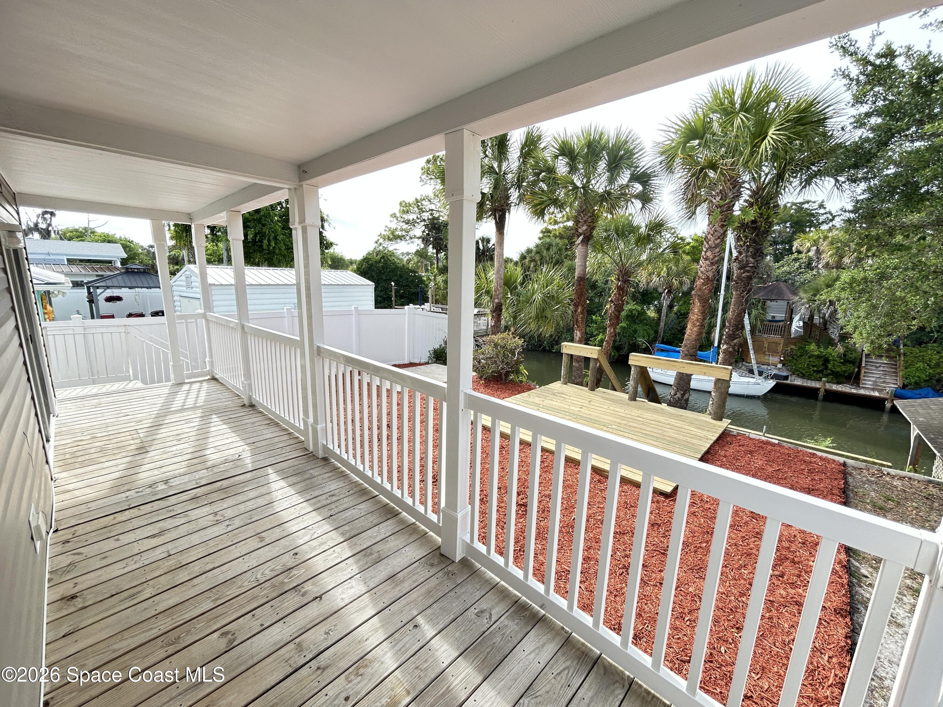 117 Lewis Street Edgewater, FL 32141 - Photo 24 of 26 a view of a chair and tables in the balcony