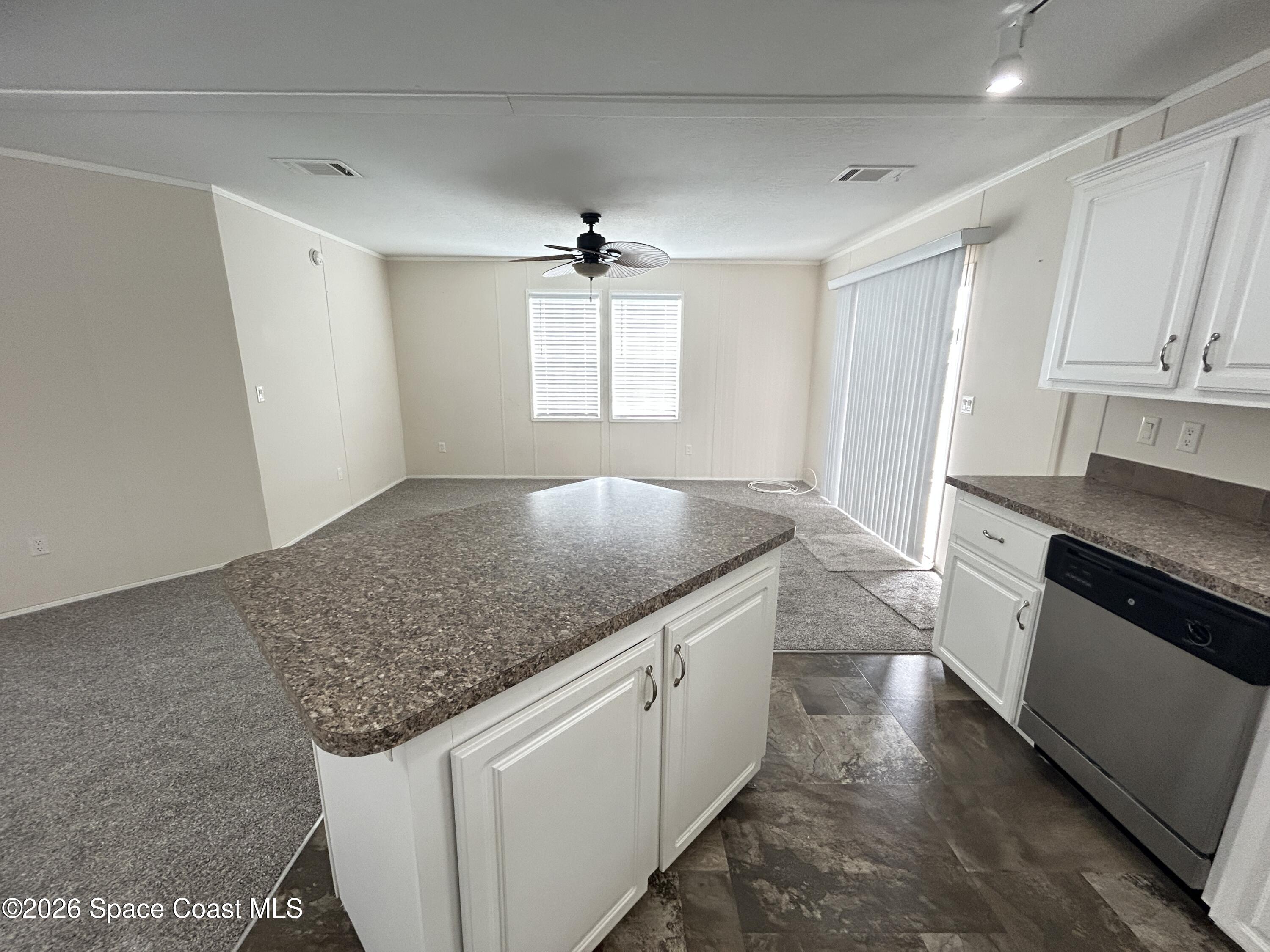 117 Lewis Street Edgewater, FL 32141 - Photo 10 of 26 a kitchen with stainless steel appliances granite countertop a sink stove and cabinets