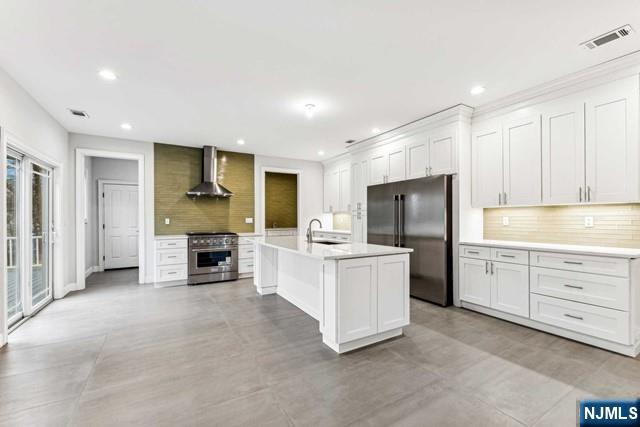 25 Jones Court Norwood, NJ 07648 - Photo 19 of 50 a kitchen with white cabinets and stainless steel appliances
