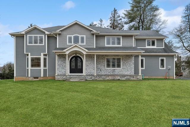 25 Jones Court Norwood, NJ 07648 - Photo 2 of 50 a front view of a house with a garden