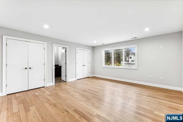 25 Jones Court Norwood, NJ 07648 - Photo 34 of 50 a view of an empty room with wooden floor and a window