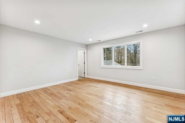 25 Jones Court Norwood, NJ 07648 - Photo 39 of 50 a view of an empty room with wooden floor and a window