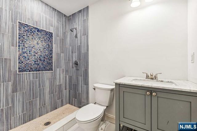 25 Jones Court Norwood, NJ 07648 - Photo 46 of 50 a bathroom with a granite countertop toilet sink and mirror