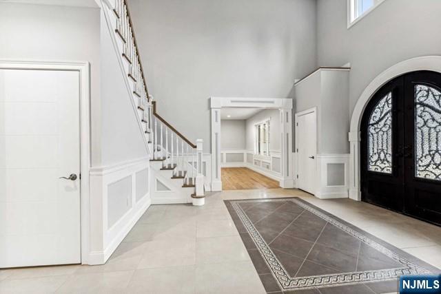 25 Jones Court Norwood, NJ 07648 - Photo 6 of 50 a view of an entryway with a floor to ceiling window and a kitchen view