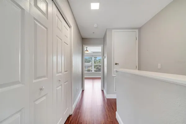 a view of a hallway with wooden floor
