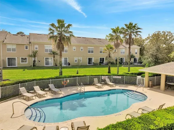 a view of swimming pool with seating space and yard view
