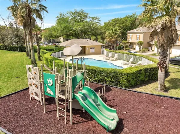 a view of a chairs and table in the backyard