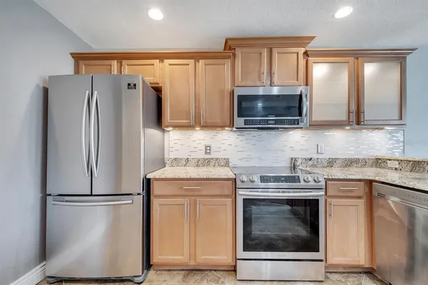 a kitchen with a refrigerator sink and microwave