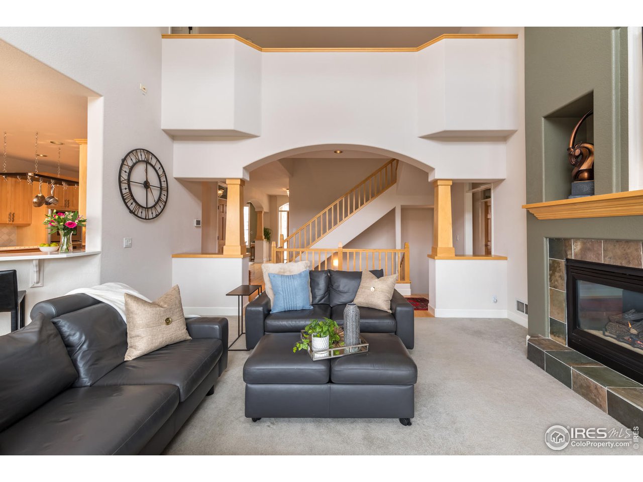 2435 Targhee Point Lafayette, CO 80026 - Photo 11 of 39 a living room with furniture a fireplace and a large window