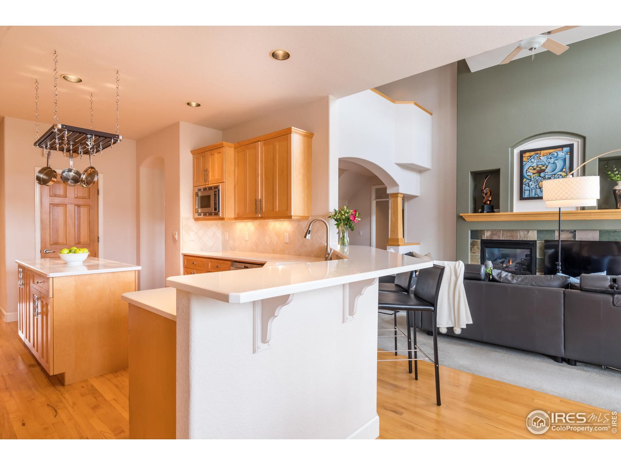 2435 Targhee Point Lafayette, CO 80026 - Photo 15 of 39 a living room with furniture a fireplace and a kitchen view