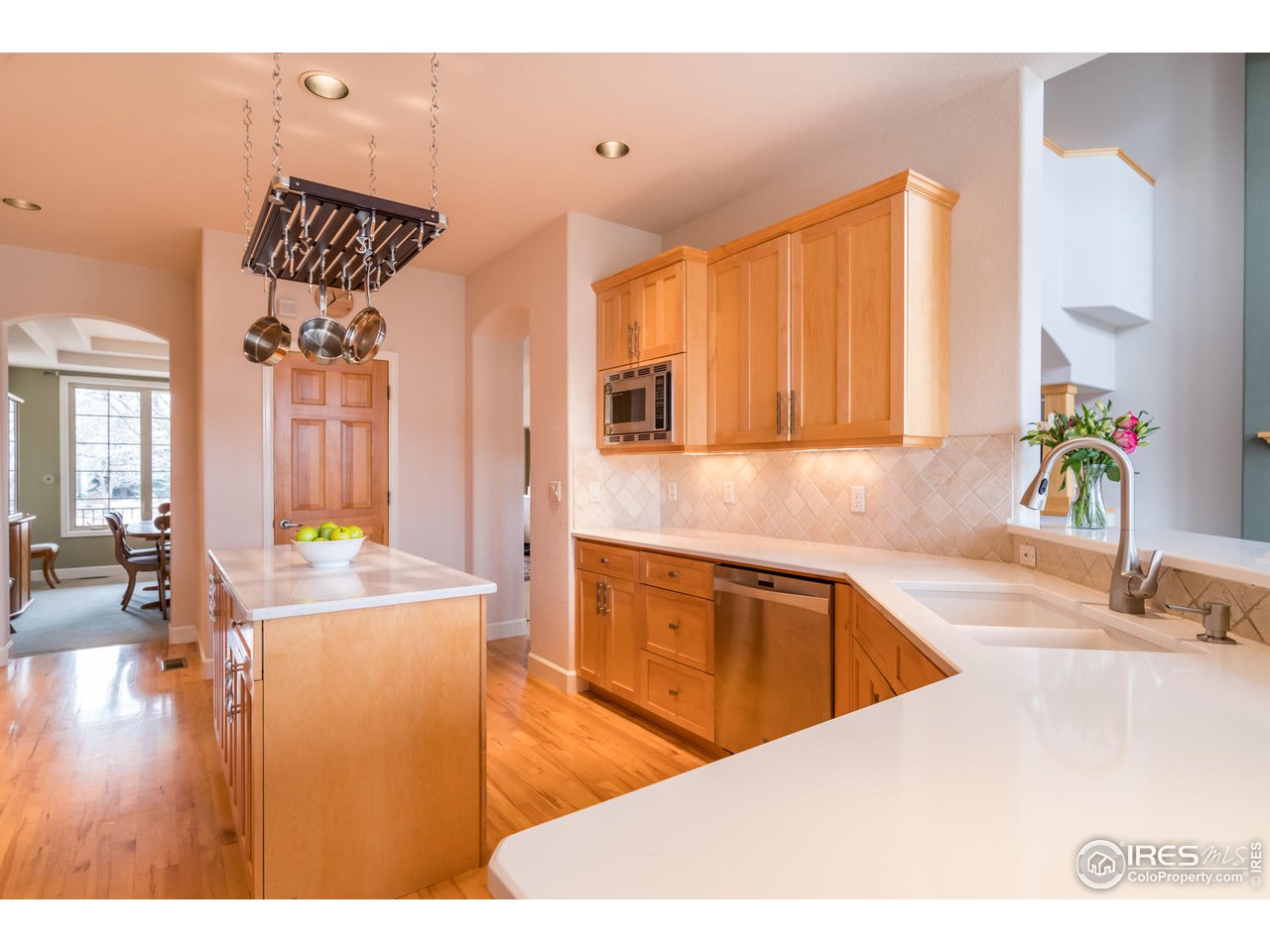 2435 Targhee Point Lafayette, CO 80026 - Photo 17 of 39 a kitchen with sink refrigerator and microwave