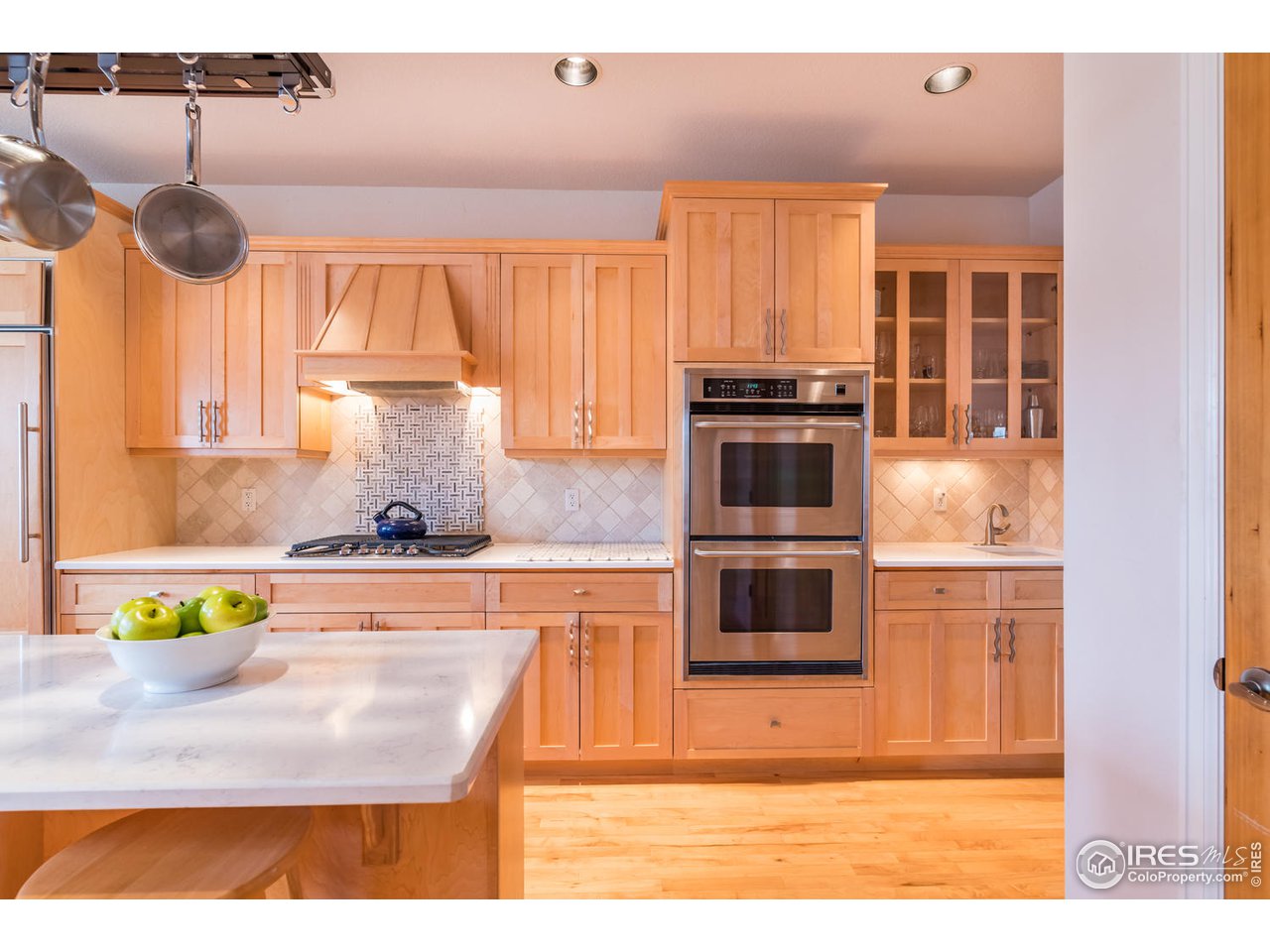 2435 Targhee Point Lafayette, CO 80026 - Photo 18 of 39 a kitchen with a stove a microwave and wooden floor