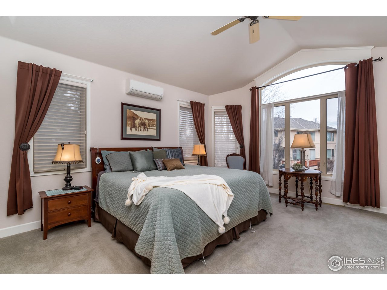 2435 Targhee Point Lafayette, CO 80026 - Photo 19 of 39 a spacious bedroom with a bed a table and large windows