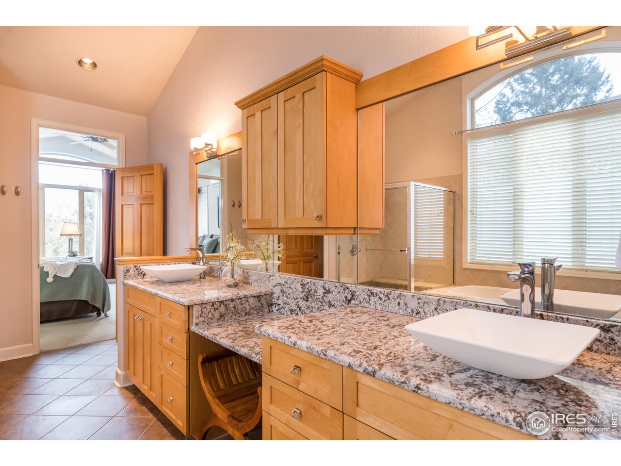 2435 Targhee Point Lafayette, CO 80026 - Photo 22 of 39 a bathroom with a granite countertop sink and a mirror