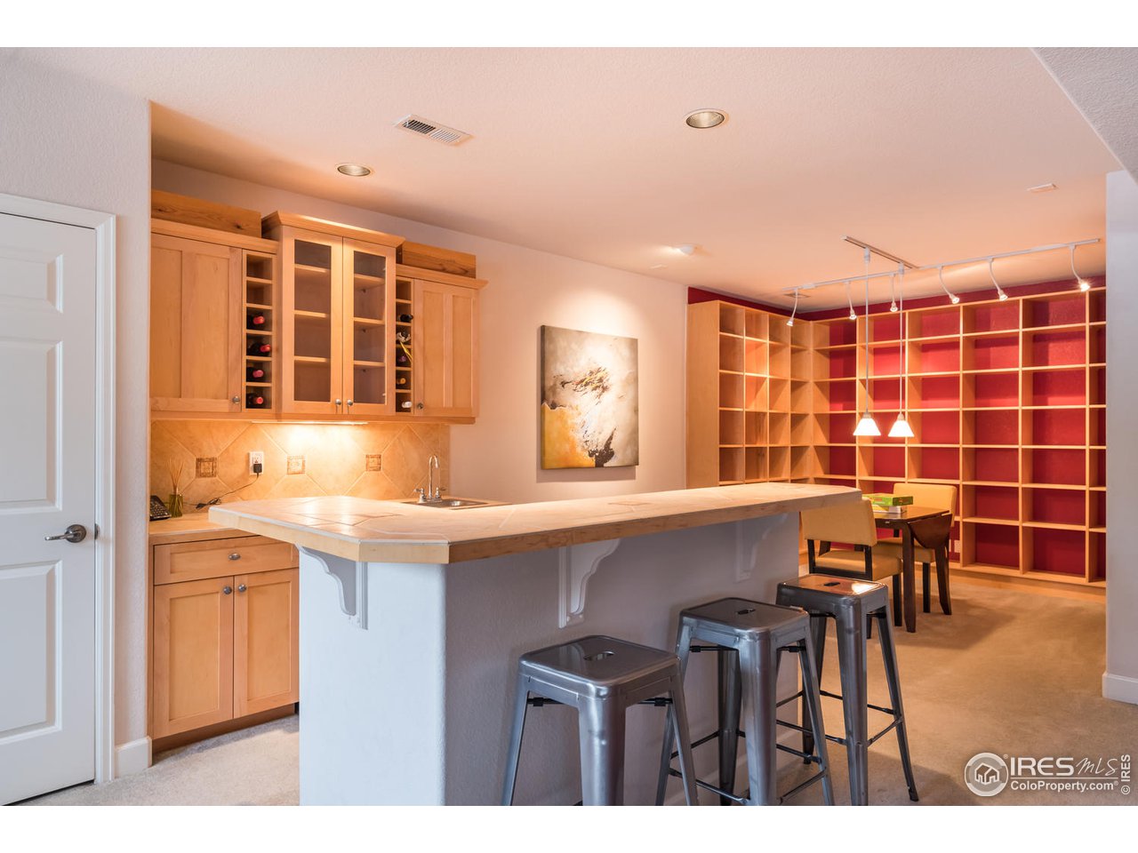 2435 Targhee Point Lafayette, CO 80026 - Photo 24 of 39 a kitchen with a sink and chairs