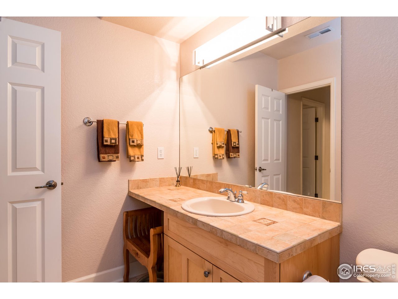 2435 Targhee Point Lafayette, CO 80026 - Photo 26 of 39 a bathroom with a sink vanity granite and a mirror