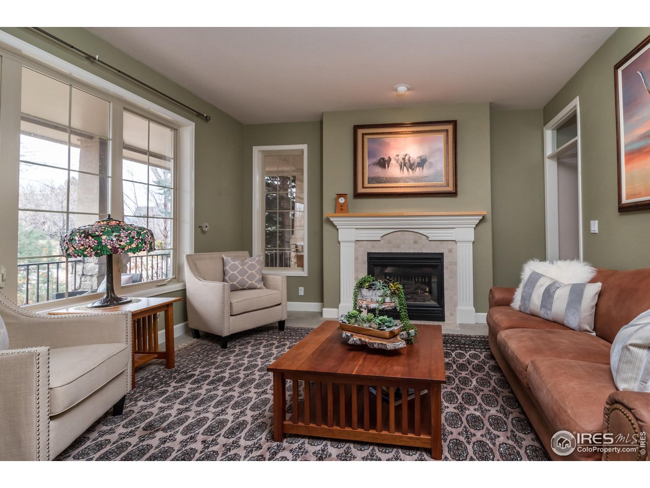 2435 Targhee Point Lafayette, CO 80026 - Photo 6 of 39 a living room with furniture a fireplace and a large window
