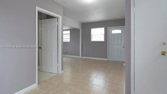 an empty room with windows and closet