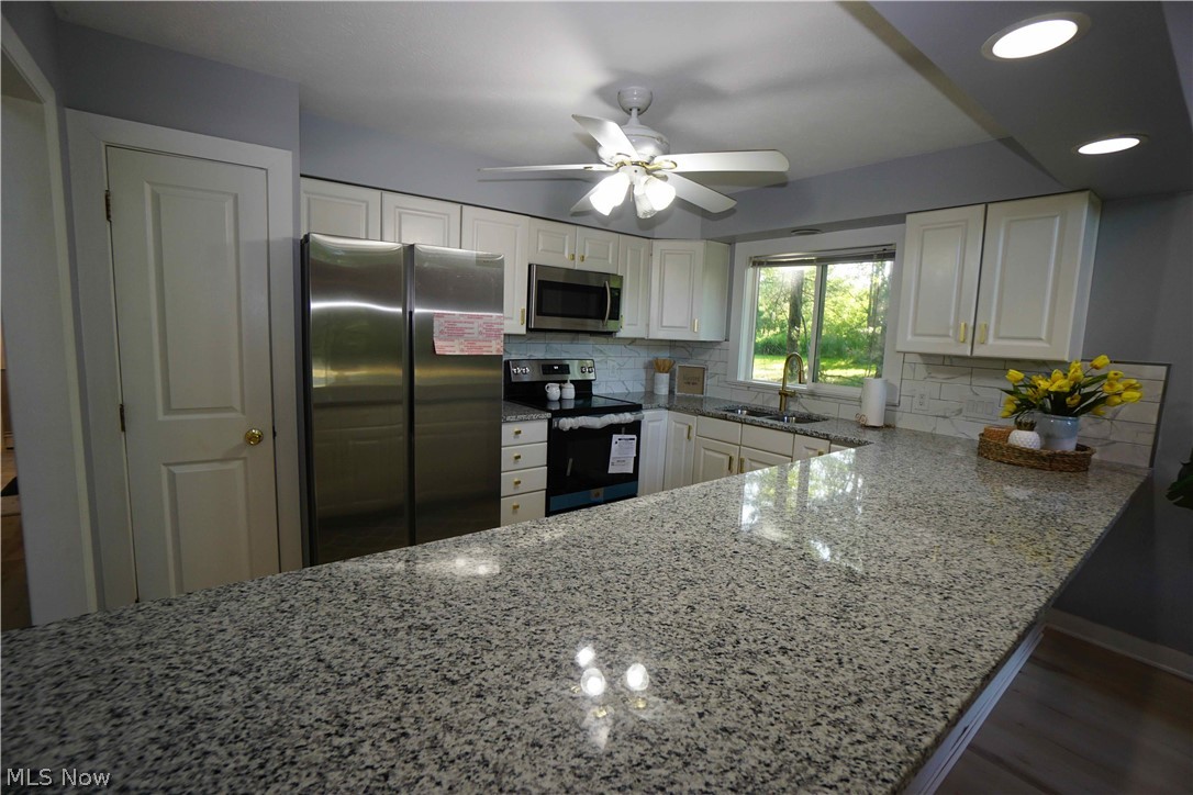 14543 Ensign Road Burton, OH 44021 - Photo 9 of 32 Open kitchen with granite countertops.