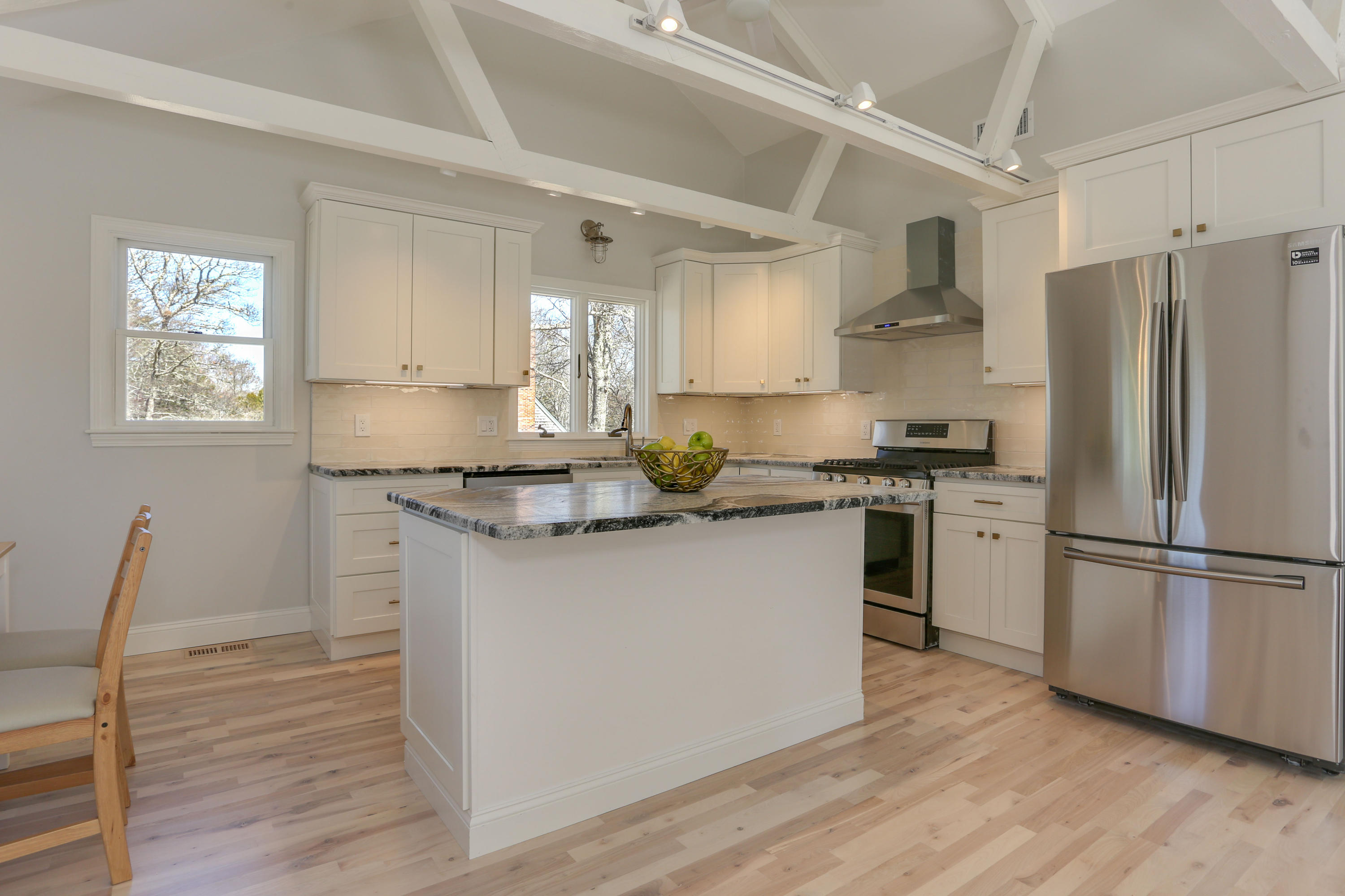 21 Cove Road Forestdale, MA 02644 - Photo 10 of 29 a kitchen with granite countertop a refrigerator stove and wooden floor