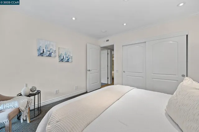 a bedroom with a bed and chair