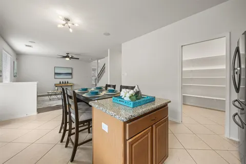a kitchen that has a table and chairs in it