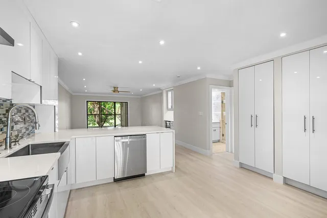 a kitchen with stainless steel appliances a white stove top oven and a refrigerator