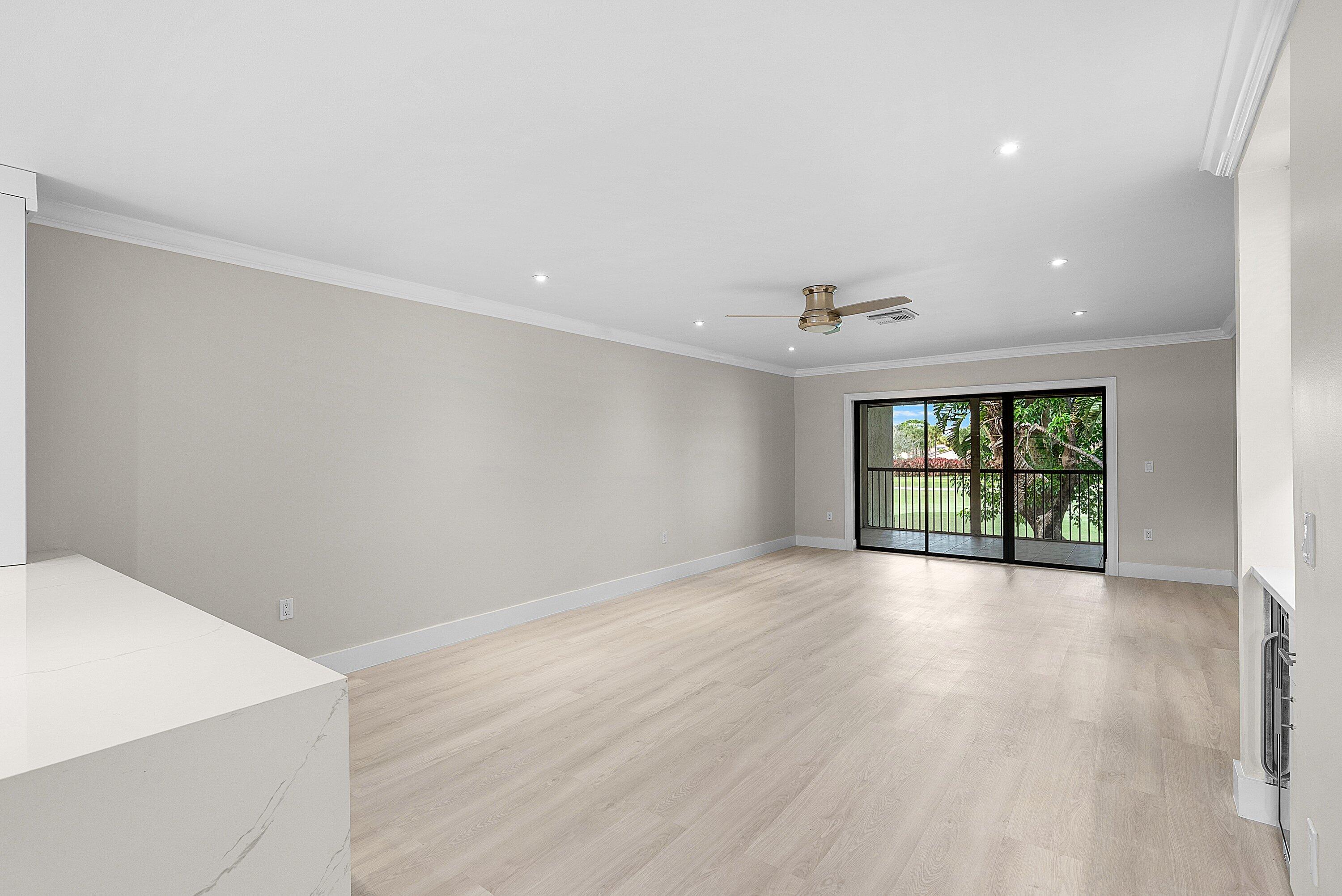 18 Stratford Drive East, Unit F Boynton Beach, FL 33436 - Photo 17 of 54 wooden floor in an empty room with a window