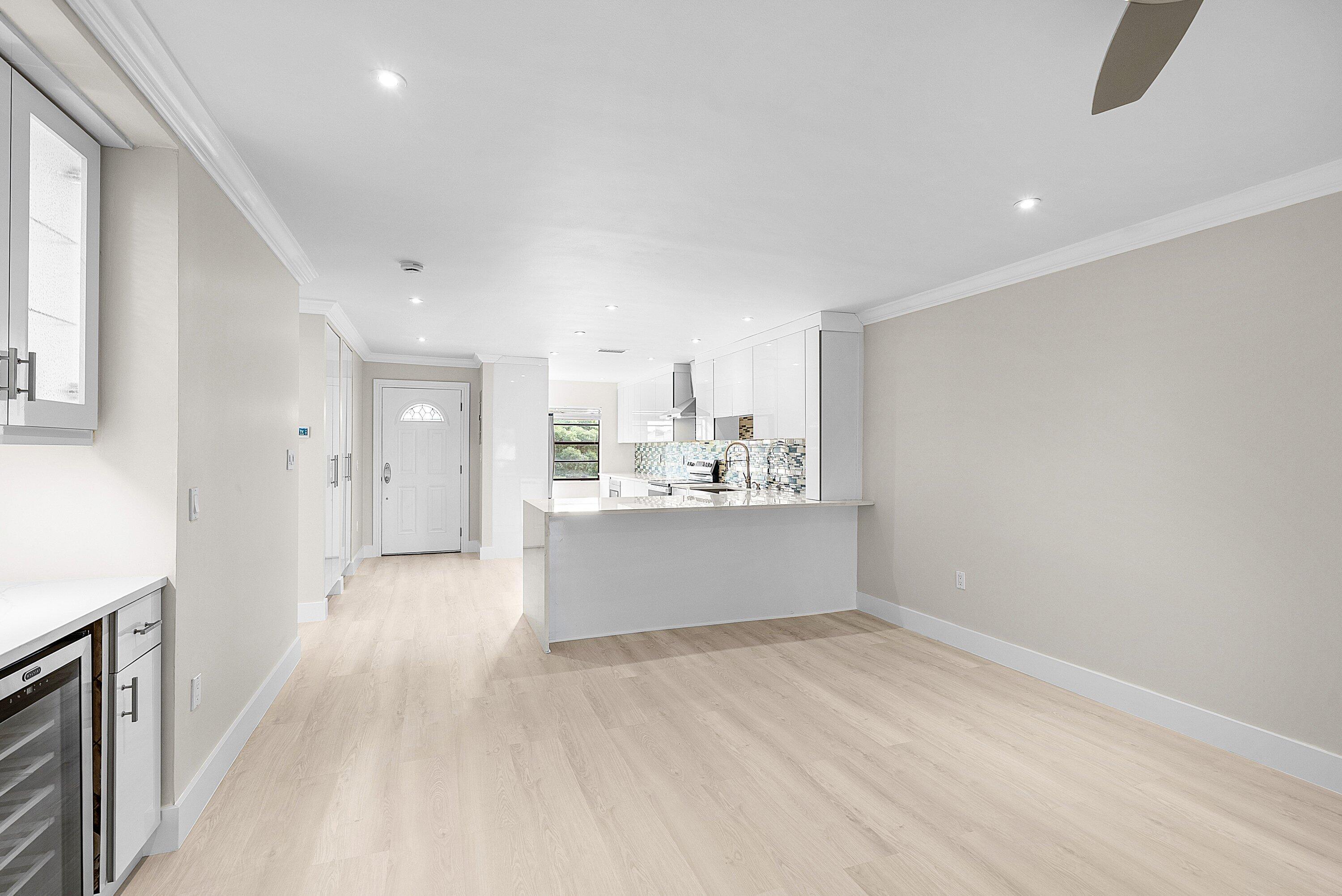 18 Stratford Drive East, Unit F Boynton Beach, FL 33436 - Photo 18 of 54 a view of a big room with wooden floor and windows