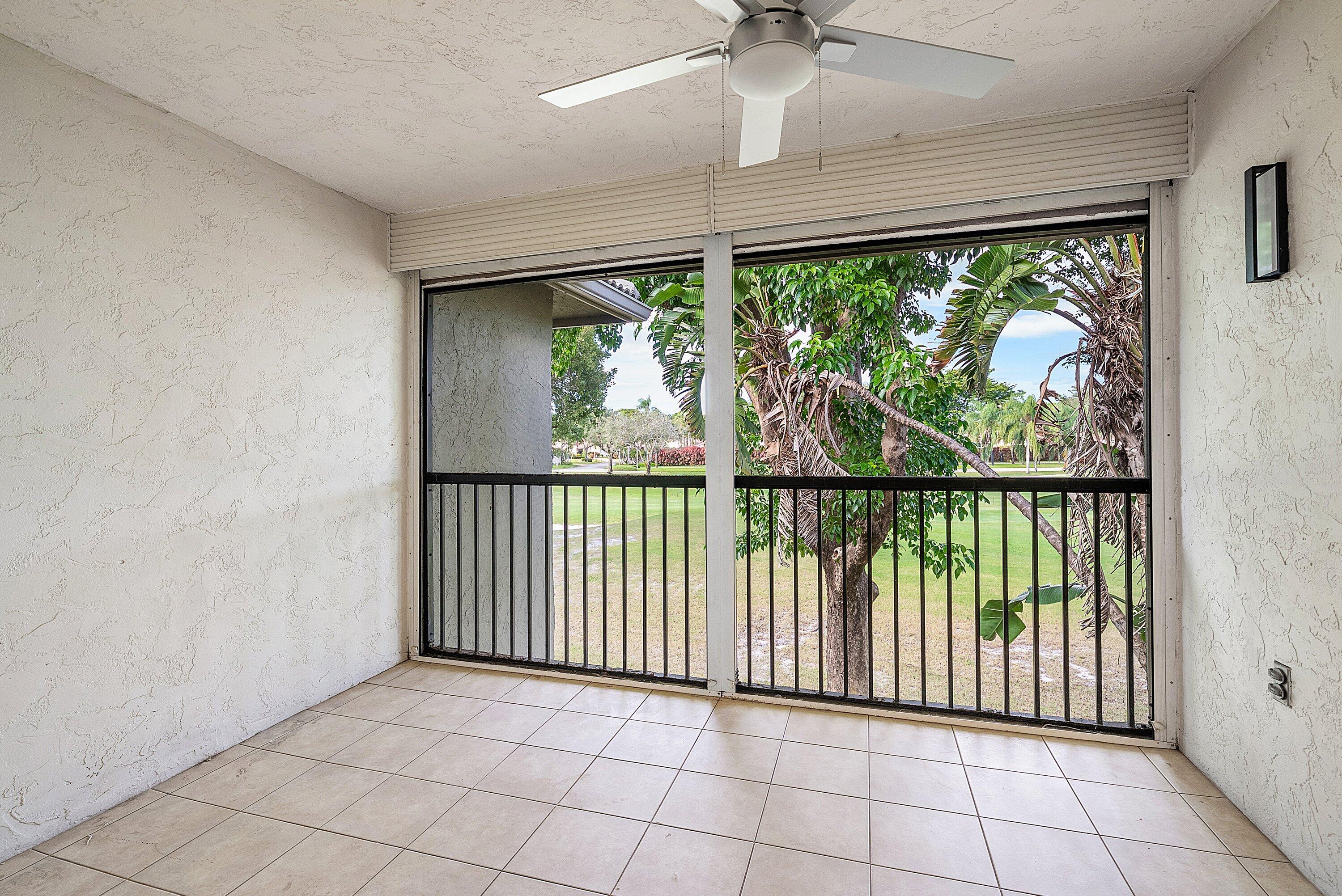 18 Stratford Drive East, Unit F Boynton Beach, FL 33436 - Photo 23 of 54 an empty room with windows and outdoor view