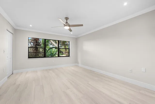 a view of an empty room with a ceiling fan