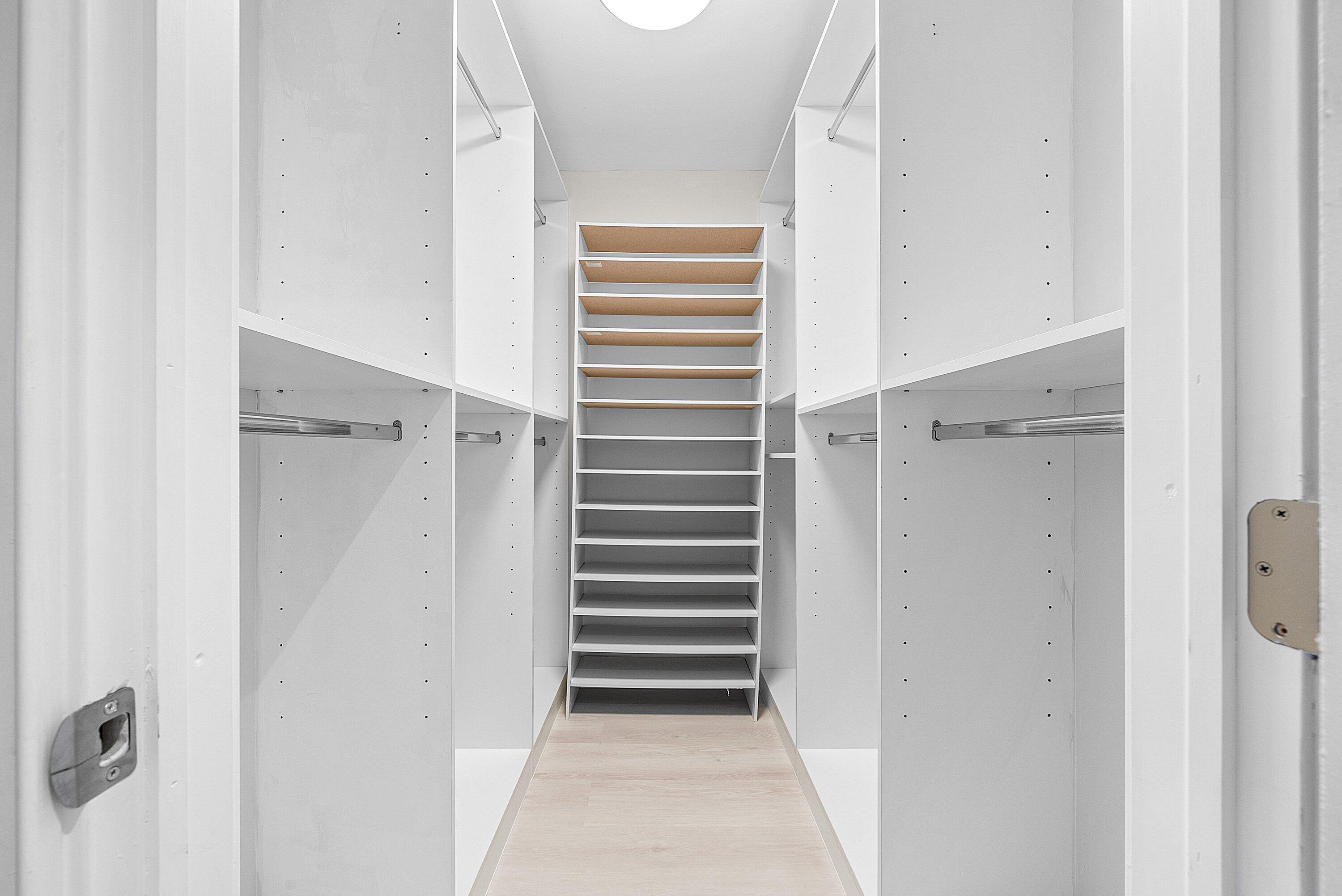 18 Stratford Drive East, Unit F Boynton Beach, FL 33436 - Photo 28 of 54 a view of closet area with empty racks