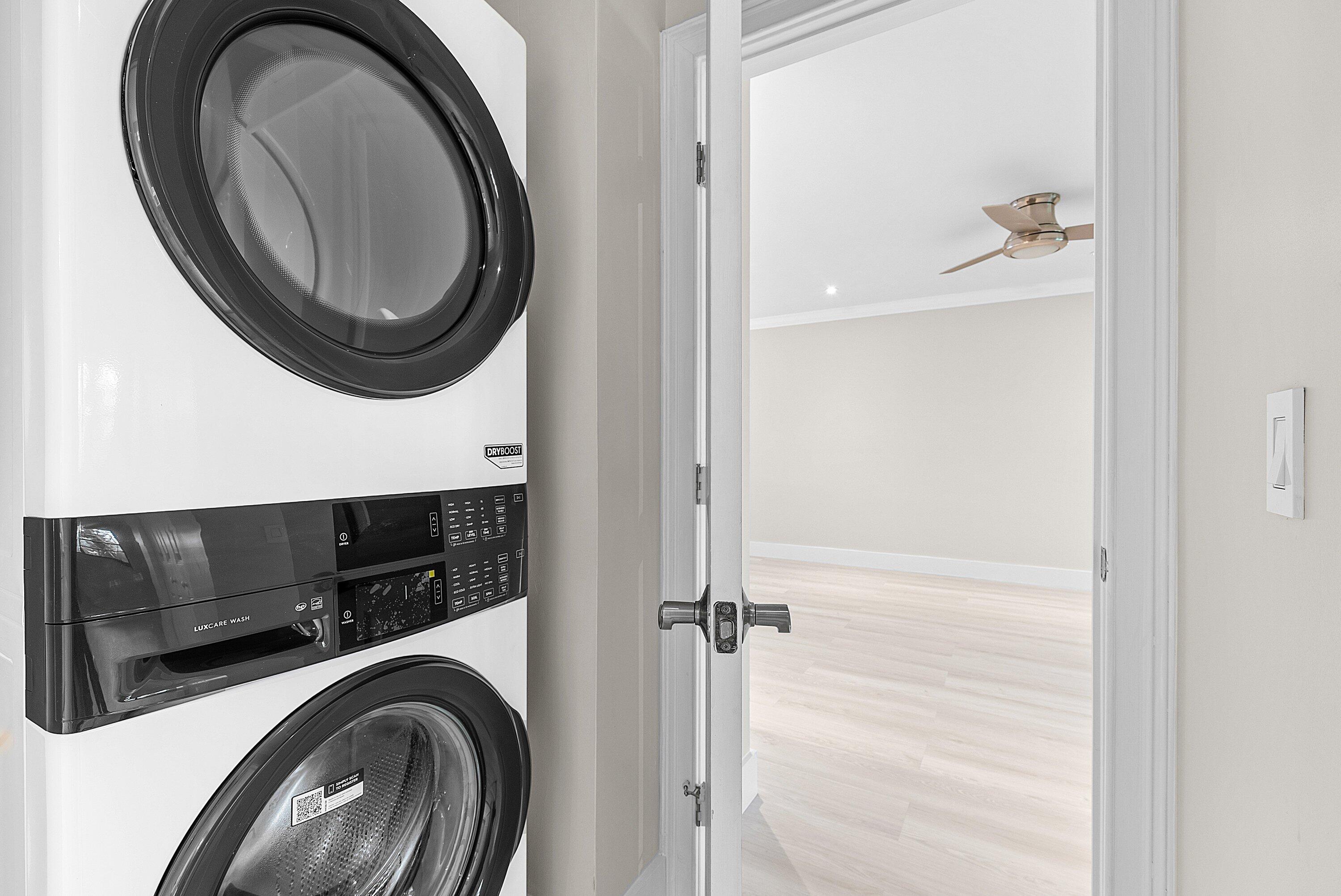 18 Stratford Drive East, Unit F Boynton Beach, FL 33436 - Photo 29 of 54 a view of a hallway with washer and dryer