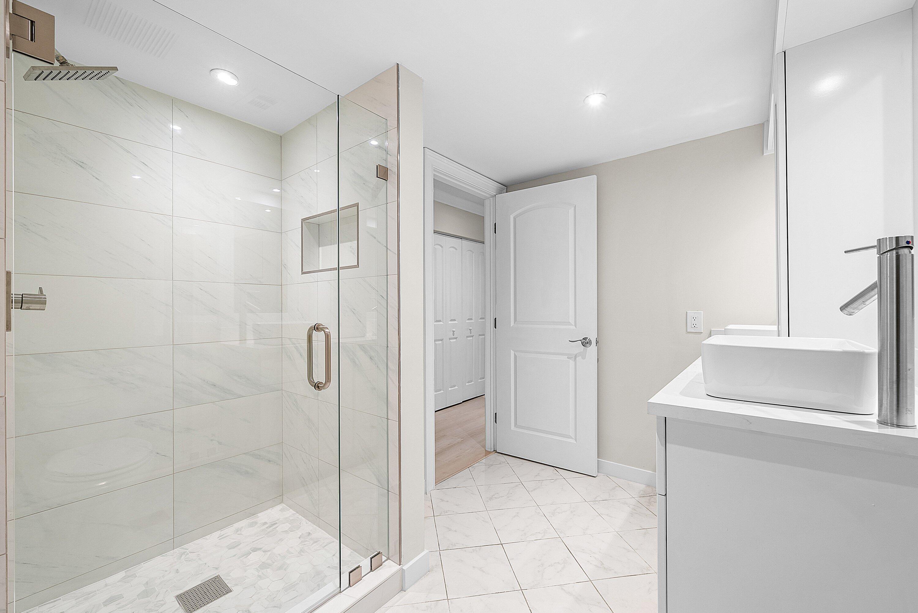 18 Stratford Drive East, Unit F Boynton Beach, FL 33436 - Photo 30 of 54 a bathroom with a shower and a sink