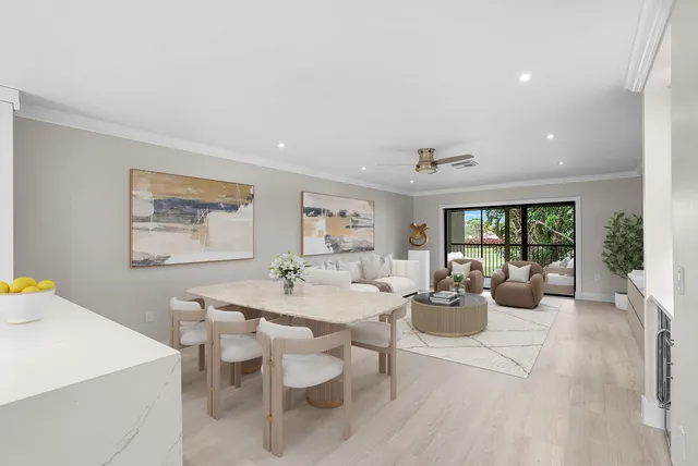 a living room with furniture and large windows