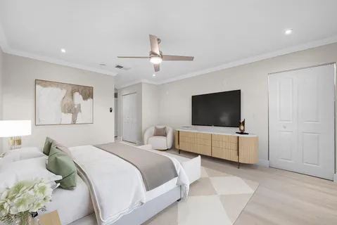 a bedroom with a bed and a flat screen tv