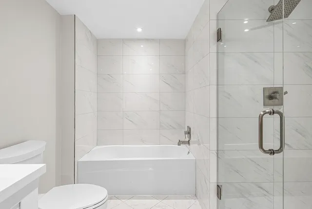 a bathroom with a toilet and a shower