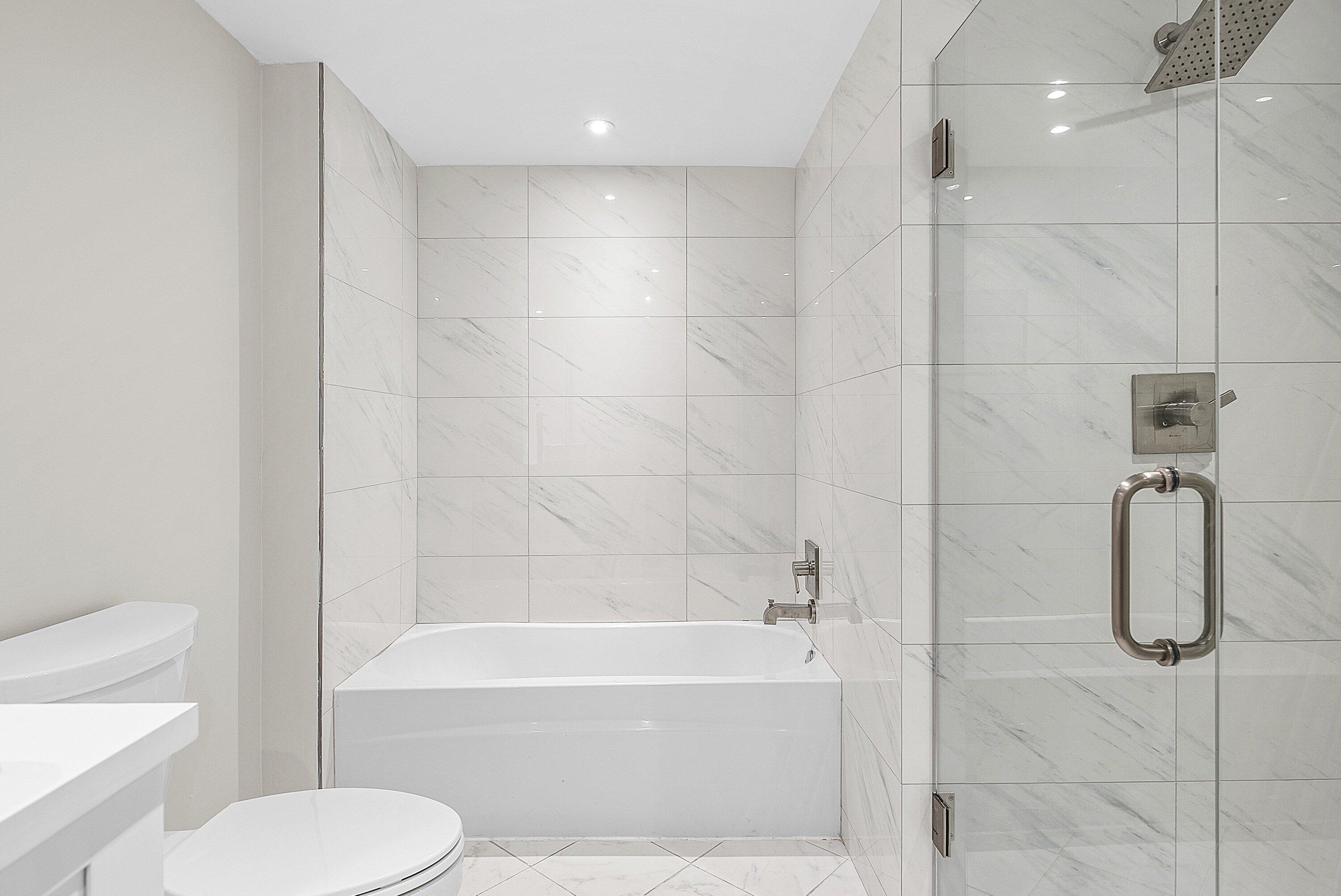 18 Stratford Drive East, Unit F Boynton Beach, FL 33436 - Photo 9 of 54 a bathroom with a toilet and a shower